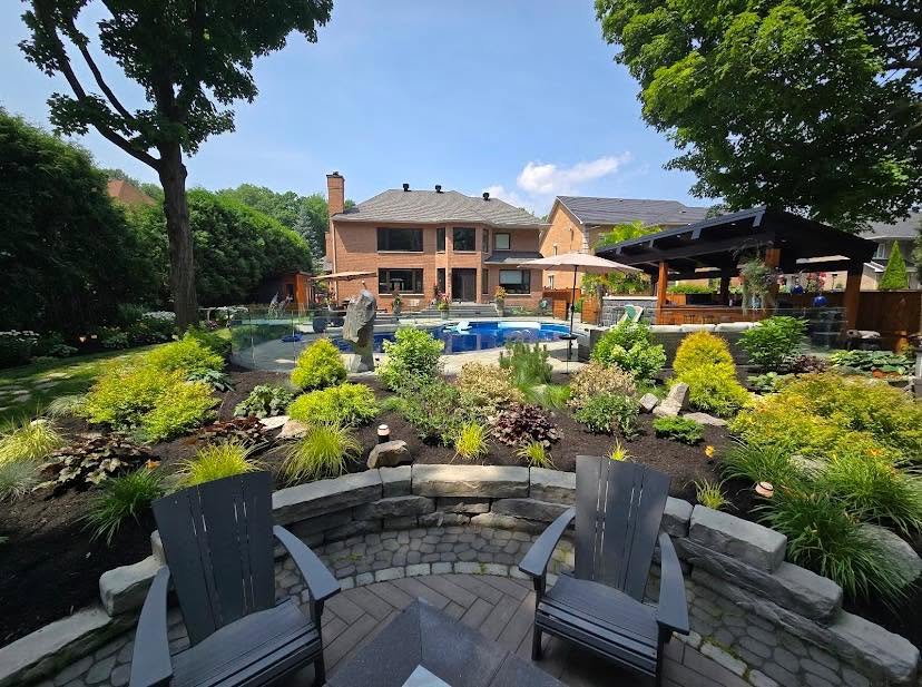 A Fractal Fern landscaped backyard — pool, gardens, stonework and a fire-pit patio